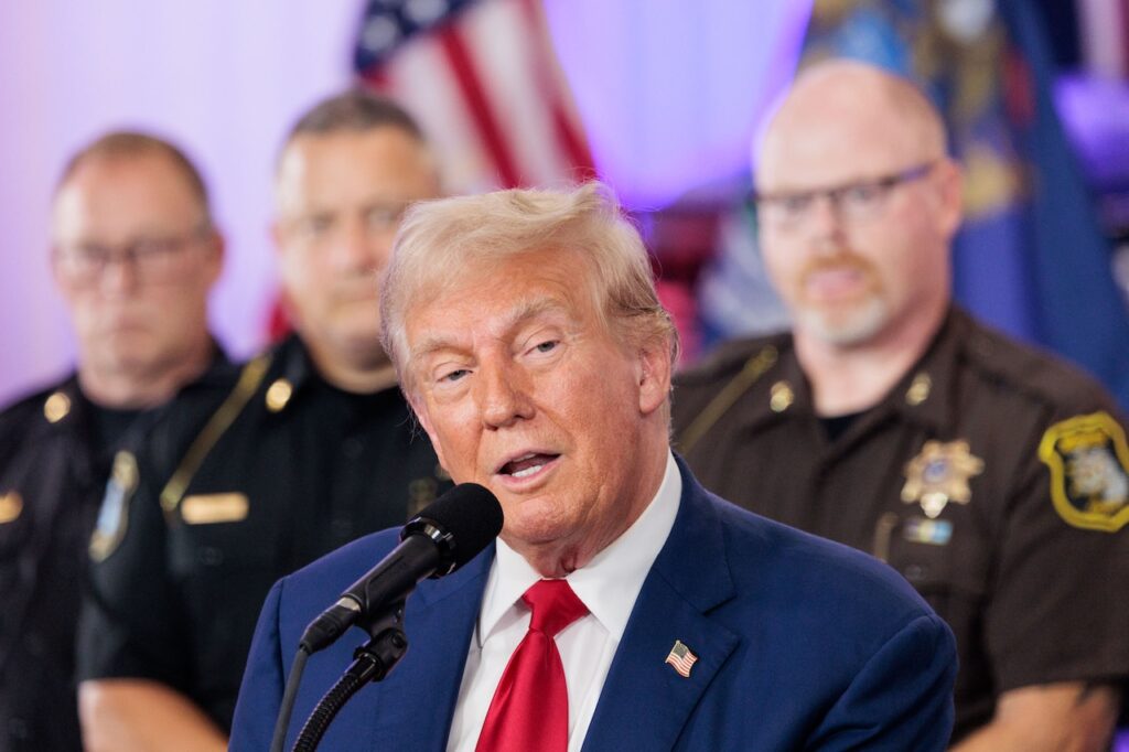 Donald Trump laughs off criticism on visiting Michigan city with historic white supremacy